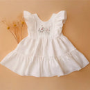 White dress with floral embroidery on a beige background, Obroi