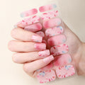 Hand holding a sheet of pink floral nail wraps against a beige background, Obroi