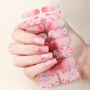 Hand holding a sheet of pink floral nail wraps against a beige background, Obroi