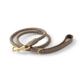 Brown braided dog leash with gold clasp on a white background, Obroi