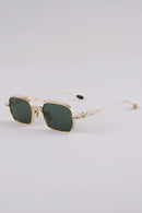 Gold-framed sunglasses with green lenses on a light gray background, Obroi