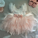 Delicate baby dress with floral details and ruffled sleeves on a soft surface, Obroi