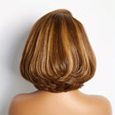 Back view of a person with a styled brown bob haircut on a light gray background, Obroi