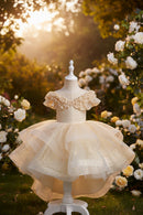 Beige sparkly dress on a mannequin against a dark background, Obroi