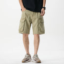 Person wearing beige cargo shorts on a white background, Obroi