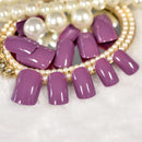 Purple nail art on a white background with pearl jewelry, Obroi