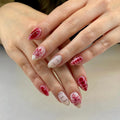 Close-up of hands with red and pink nail polish on a neutral background, Obroi