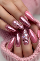Close-up of hands with pink and glittery nails featuring heart designs, Obroi