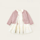 Pink cardigan with white dress on a light beige background, featuring 'Obroi'.