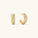 Pair of gold hoop earrings on a white background with product details, Obroi