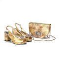 Gold high-heeled shoes with embellishments and a matching handbag on a white background, Obroi