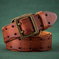 Brown leather belt with brass buckle on a green background, Obroi