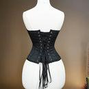 Black corset on a mannequin against a brown background, Obroi