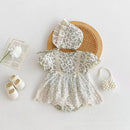 White lace baby outfit with bonnet, shoes, and bracelet on a light , Obroi