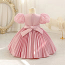 Pink dress with puffed sleeves on a mannequin against a decorative background, Obroi