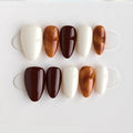 Set of brown and white nail tips on a white background, Obroi