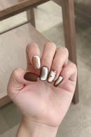 Hand with metallic nail polish on a blurred background, Obroi
