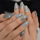 Close-up of a hand with gray nail polish and gold accents on a blurred background ,Obroi