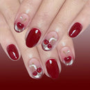 Nails with red polish and cherry designs on a red background, Obroi