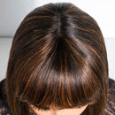 Close-up of a person with brown hair styled in a bob cut against a neutral background, Obroi