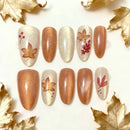 Nail art set with autumn leaf designs on a white background with gold leaves, Obroi