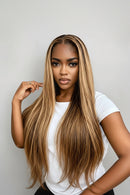 A woman modeling a long, straight lace-front wig with highlighted blonde-brown tones against a light gray background. The image includes promotional text overlays: 'Obroi' in the top left, 'HD Lace Wig' in the top right, and a purple banner at the bottom reading 'Buy Now 3-5 days to arrive' with delivery icons, Obroi