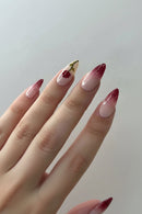 Nail art with a red rose design on a neutral background, Obroi