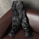 Black leather motorcycle pants on a brown leather couch, Obroi
