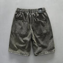 Gray denim shorts with a brand label on a gray background, Obroi