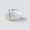 White clutch bag with gold chain on a light gray background, Obroi
