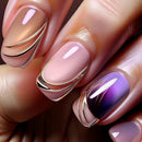 Close-up of a hand with pink and purple nails featuring gold accents, Obroi