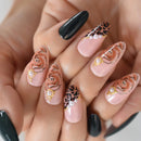Nails with floral and leopard print designs on a light background ,Obroi
