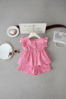 Pink children's dress with ruffled sleeves and shorts on a white surface, Obroi