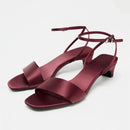Maroon sandals with thin straps on a light gray background, Obroi