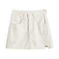 White denim skirt with floral embroidery on a white background, Obroi