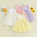 Four children's dresses in white, pink, yellow, and purple with floral patterns on a beige background, Obroi