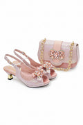 Pink high-heeled shoes and matching handbag with decorative elements on a white background, Obroi