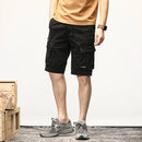 Person wearing black cargo shorts on a white background, Obroi