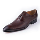 Brown leather dress shoe on a white background