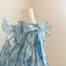 Blue striped dress with a large bow on a mannequin against a beige background, Obroi
