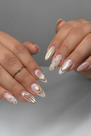 Close-up of hands with pink and gold nail art on a neutral background, Obroi