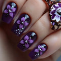 Nails with purple floral design and white accents on a dark background, Obroi