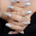 Close-up of hands with silver glittery nail polish and rings, Obroi