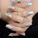 Close-up of hands with silver glittery nail polish and rings, Obroi