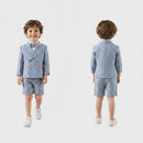 Child wearing a blue checkered suit standing against a white background, Obroi