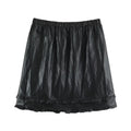 A black crinkled faux-leather mini skirt with an elastic waistband and a ruffled hem, shown flat against a white background, Obroi