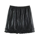 A black crinkled faux-leather mini skirt with an elastic waistband and a ruffled hem, shown flat against a white background, Obroi