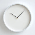 White wall clock with black hands on a white background, Obroi