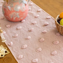 Decorative pink table runner with floral patterns on a wooden table, Obroi