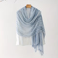 Blue striped shawl draped over a mannequin on a white background, Obroi